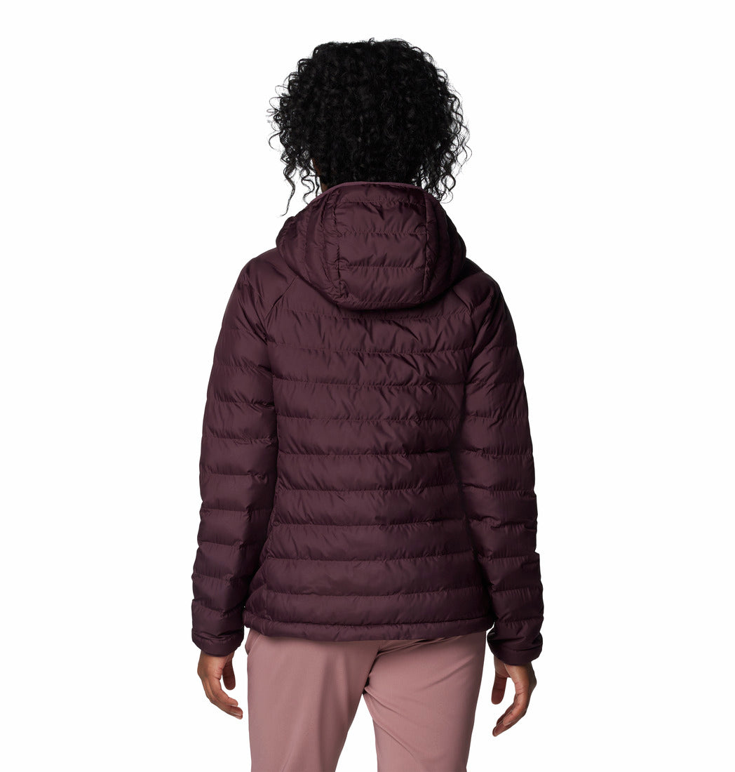 Person wearing a purple puffer jacket on a white background