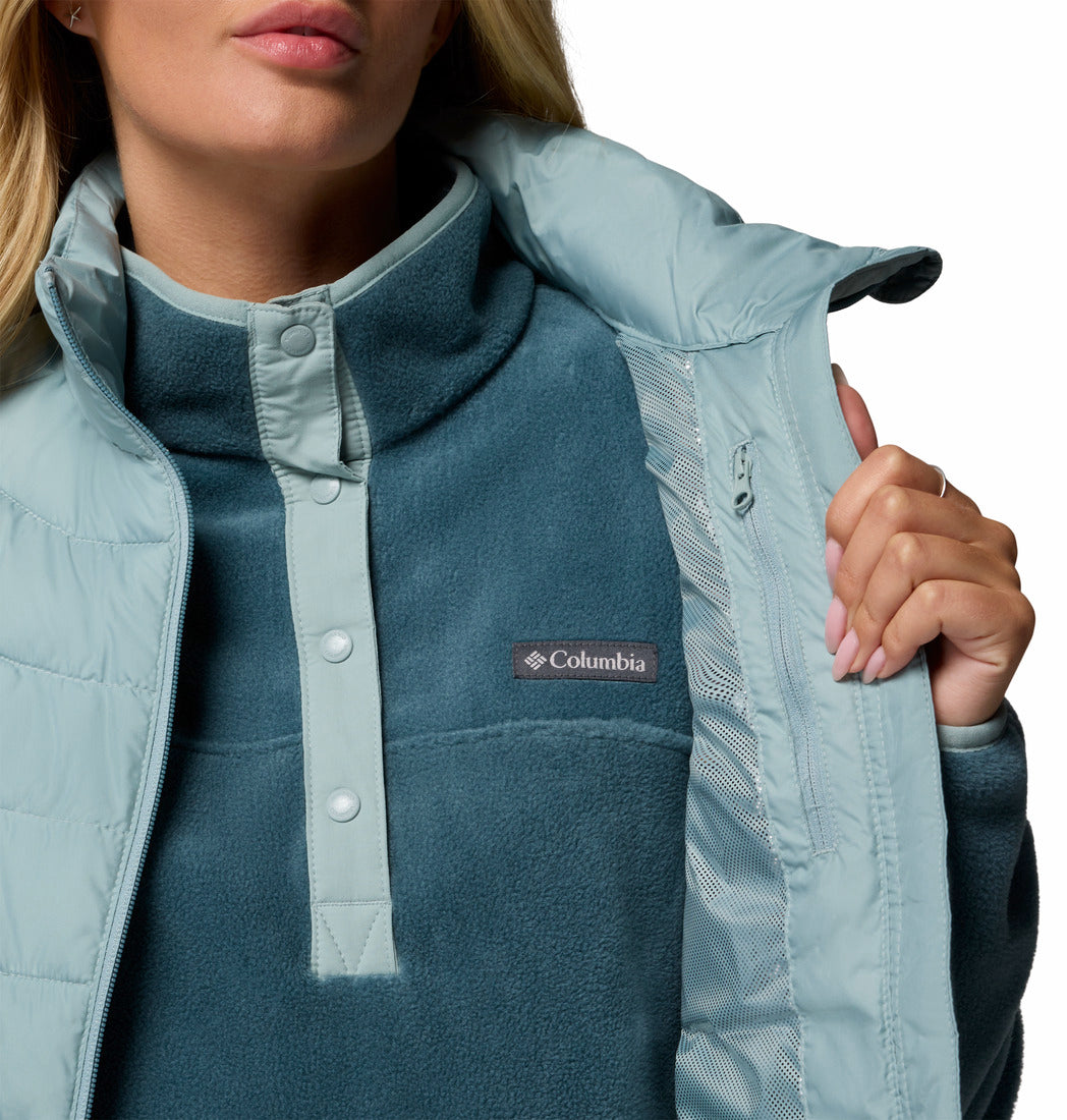 Person wearing a Columbia jacket with a close-up on the brand logo.