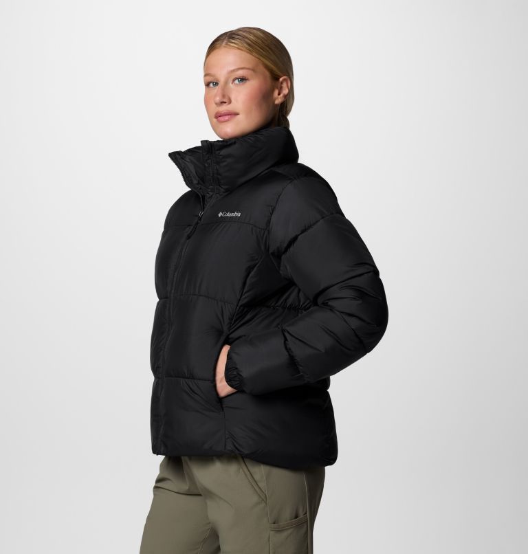 Person wearing a black Columbia jacket on a light gray background