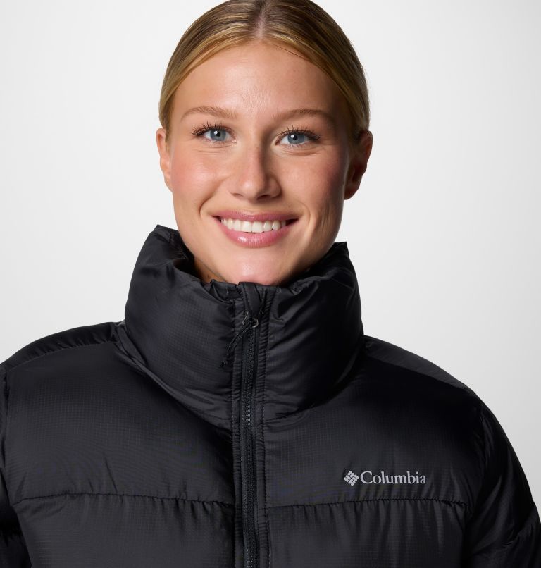 Woman wearing a black Columbia jacket on a white background