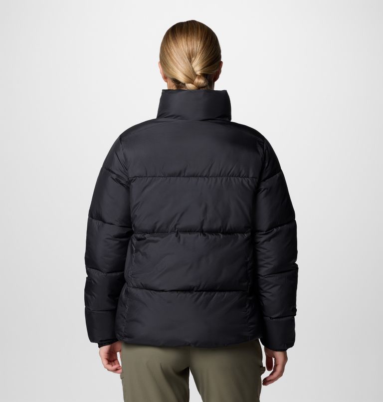 Person wearing a black puffer jacket on a white background