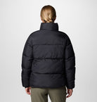 Person wearing a black puffer jacket on a white background