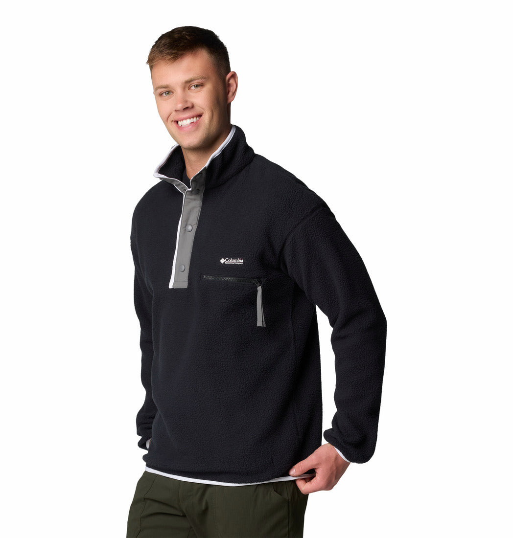 Man wearing a black and gray pullover with Columbia logo on a white background