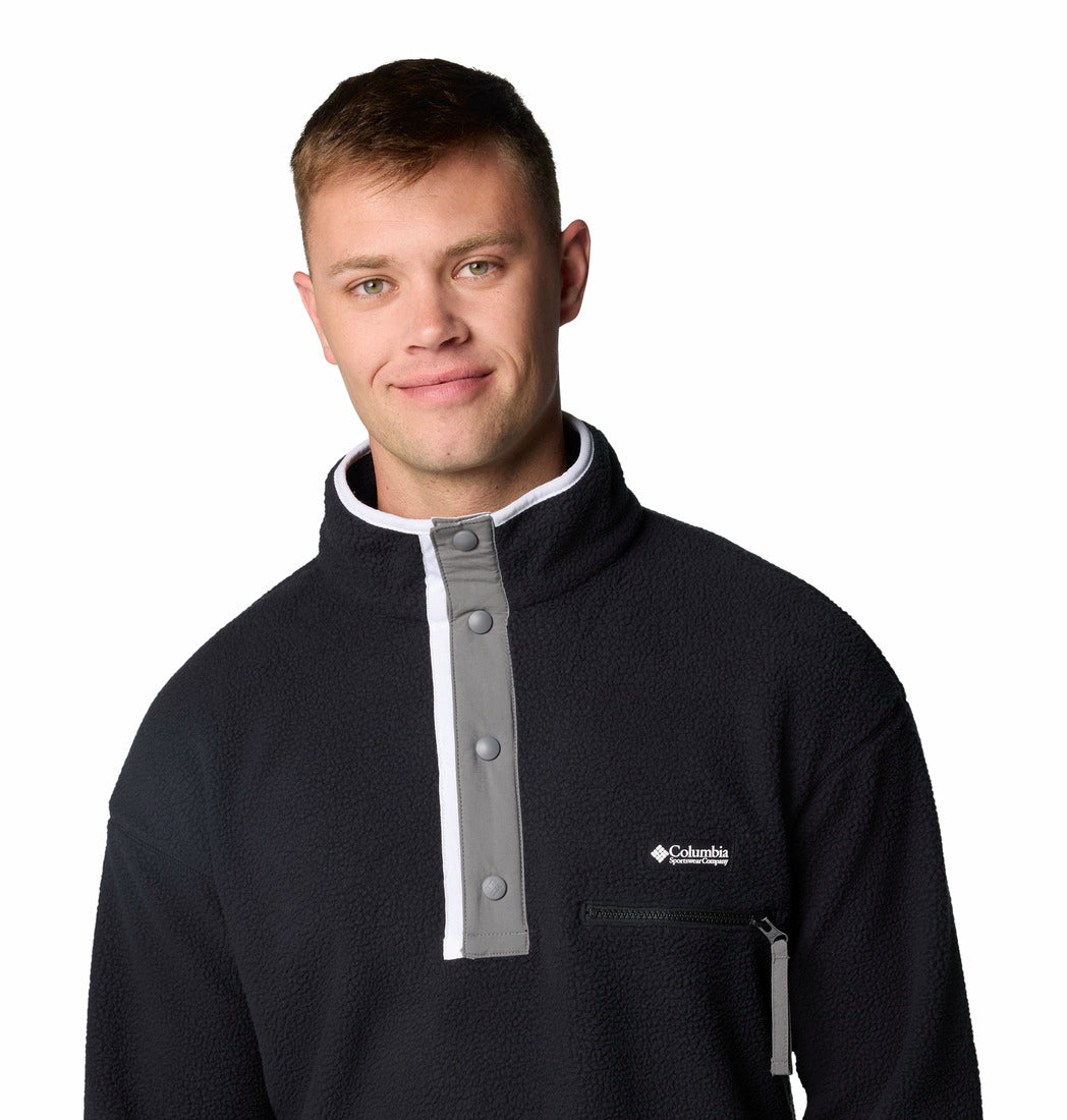 Man wearing a black and gray Columbia pullover on a white background