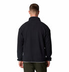 Man wearing a black fleece jacket on a white background