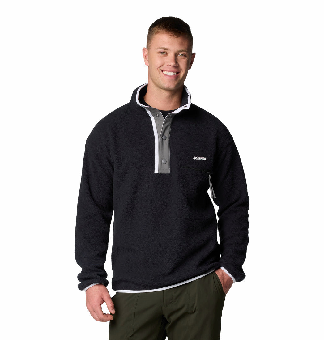 Man wearing a black pullover with a logo on a white background