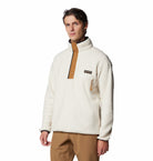Man wearing a white fleece pullover with a brand logo on a white background