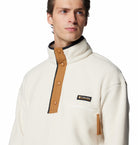 Man wearing a white fleece jacket with brown accents and Columbia logo on a white background