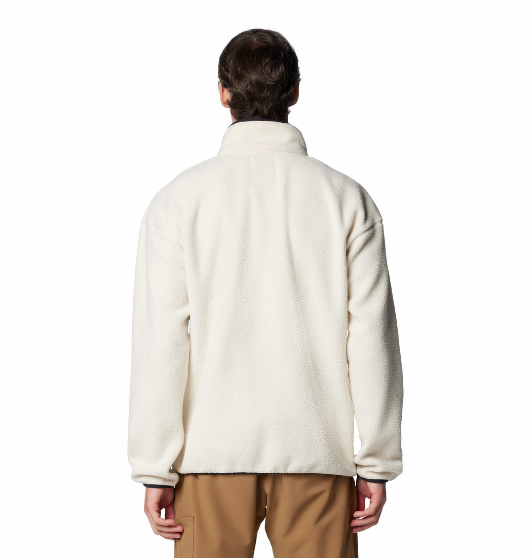 Person wearing a cream-colored fleece jacket on a white background
