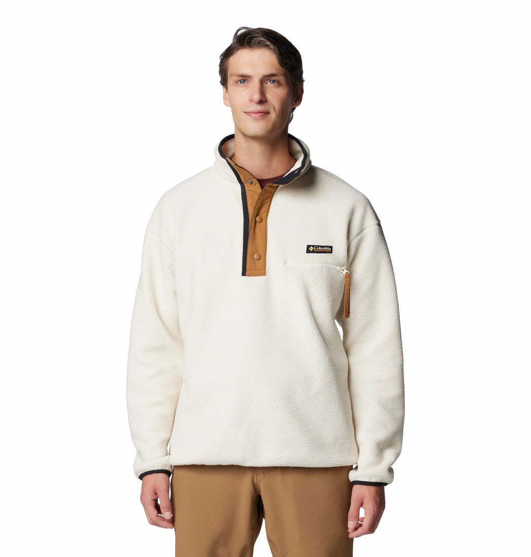 Man wearing a white fleece pullover with brown accents on a white background