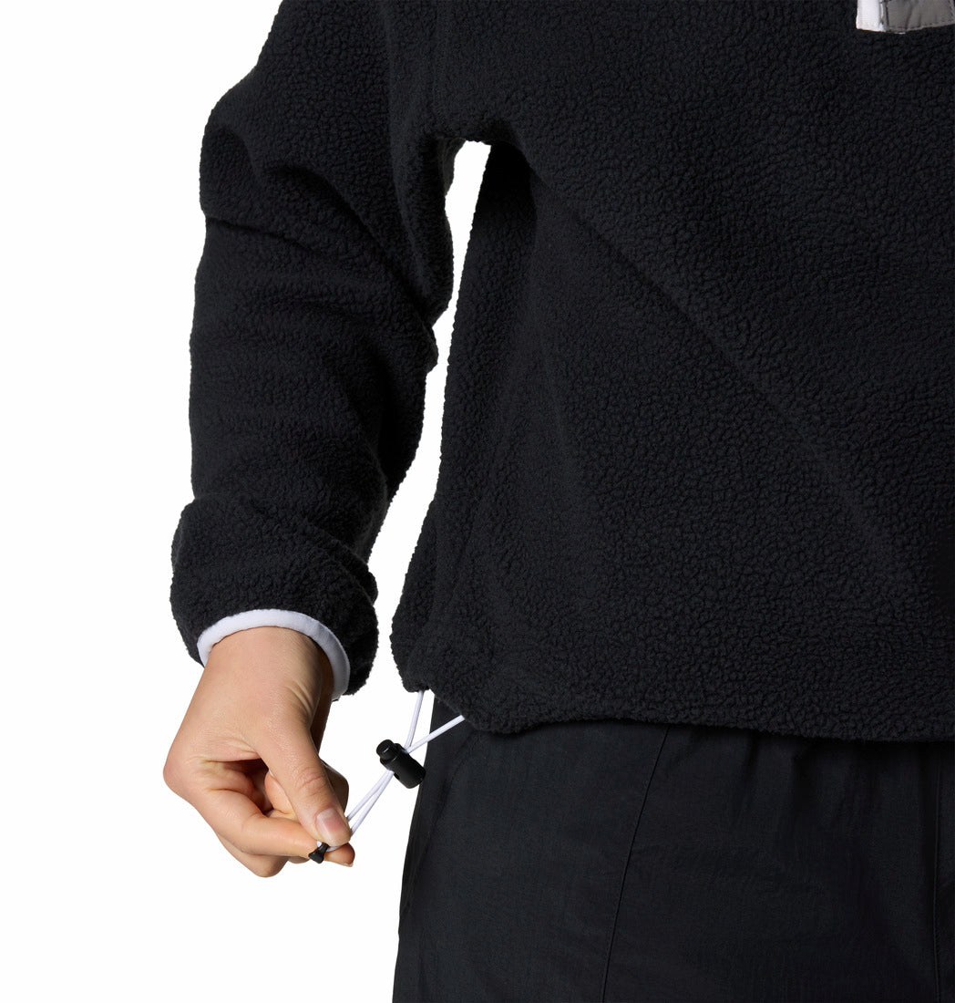 Person wearing a black fleece jacket with a white background
