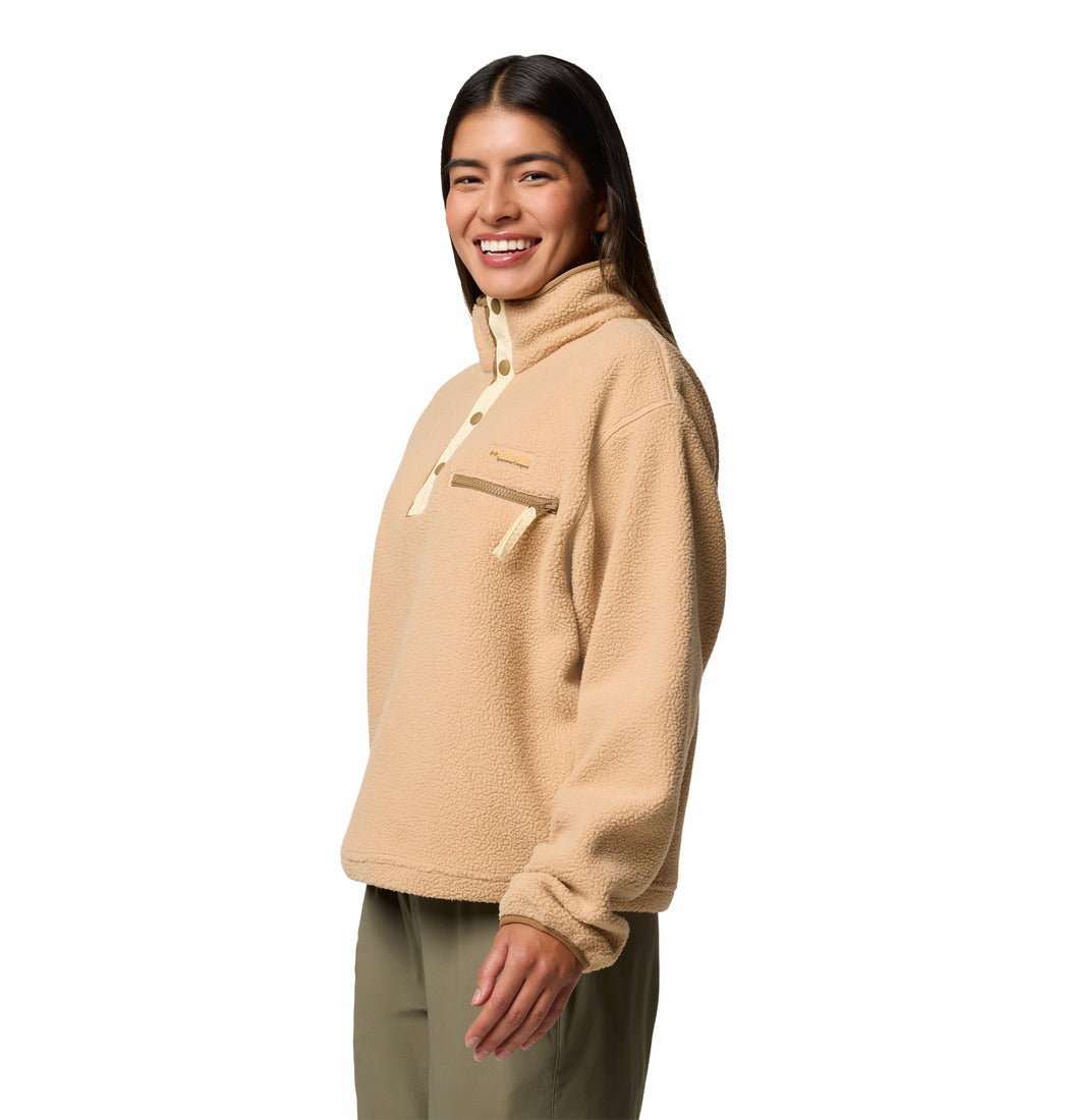Person wearing a beige fleece pullover on a white background