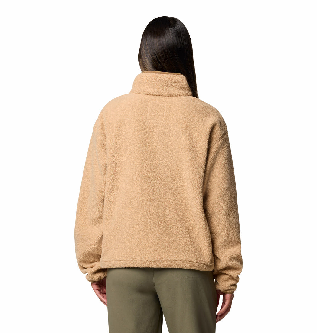 Person wearing a beige fleece jacket on a white background