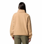 Person wearing a beige fleece jacket on a white background