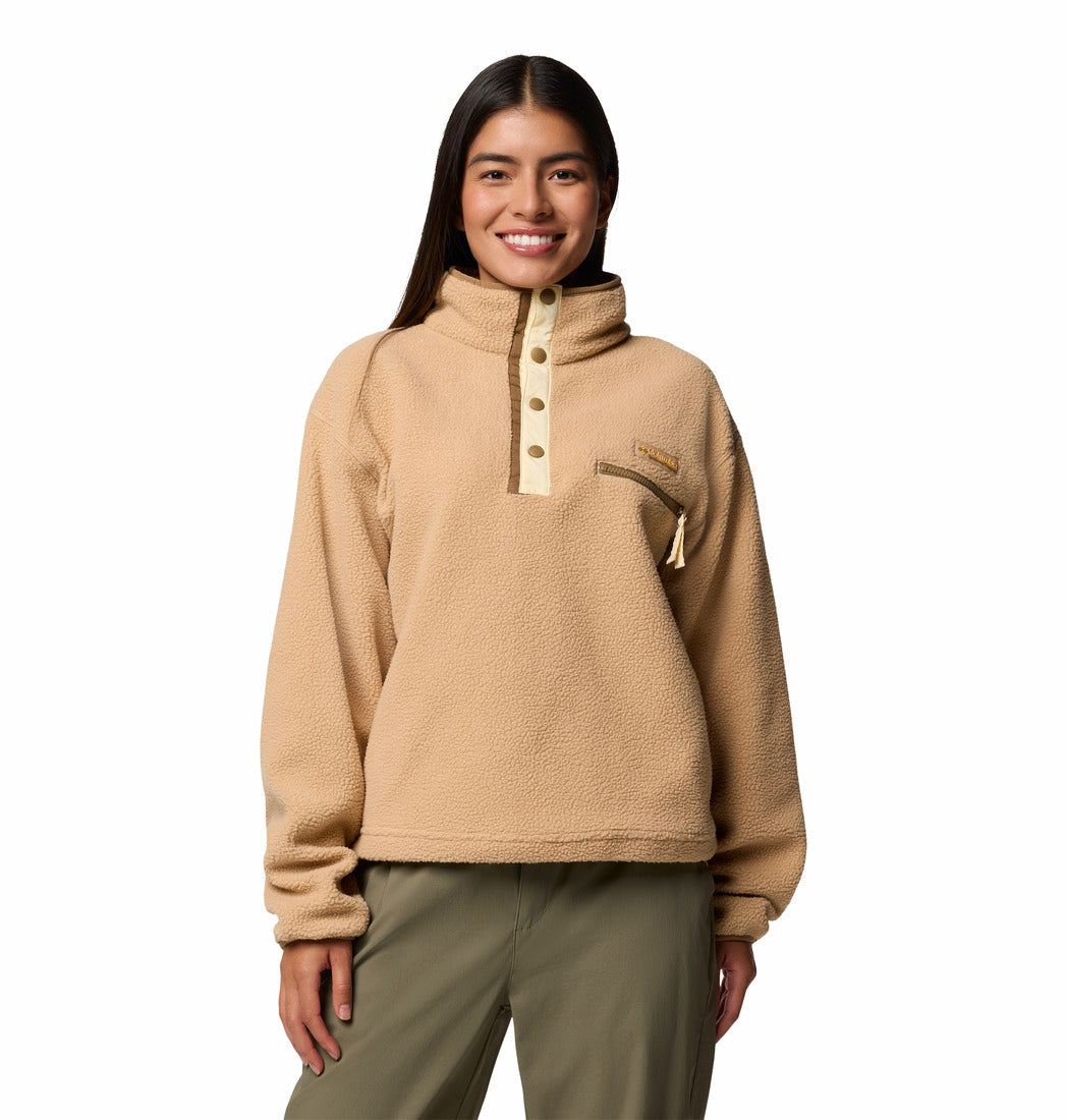 Woman wearing a beige fleece pullover with a white background