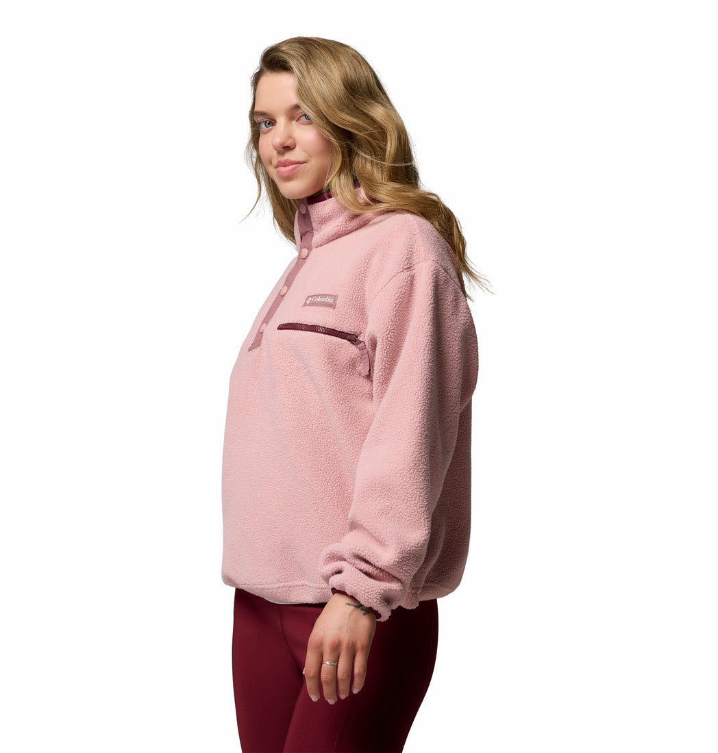 Woman wearing a pink fleece pullover on a white background