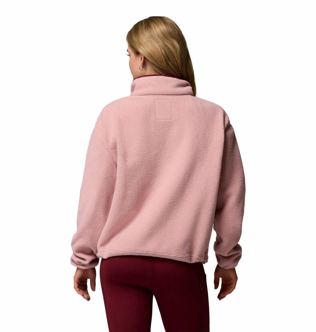 Person wearing a pink fleece jacket on a white background