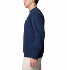 Person wearing a navy blue sweatshirt on a white background