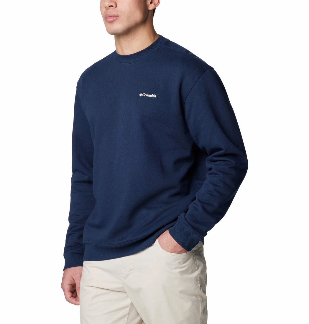 Person wearing a navy blue sweatshirt with a brand logo on a white background