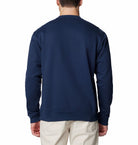 Navy blue sweatshirt worn by a person on a white background