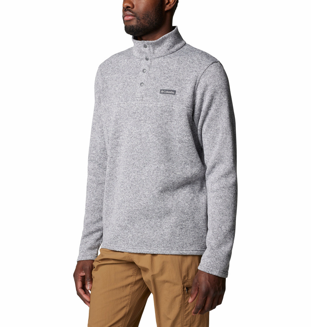 Man wearing a gray pullover with a brand logo on a white background