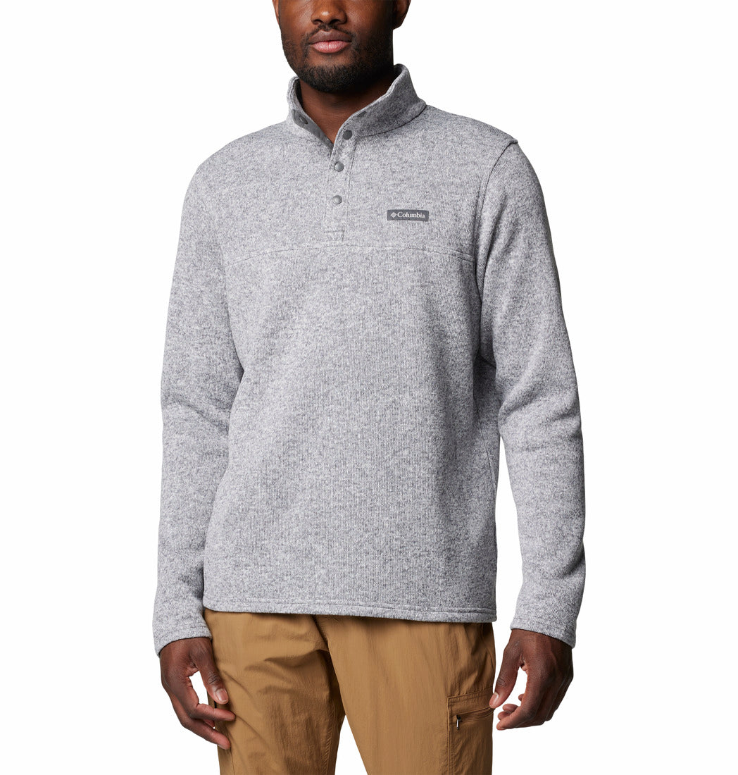 Man wearing a gray pullover with a brand logo on a white background
