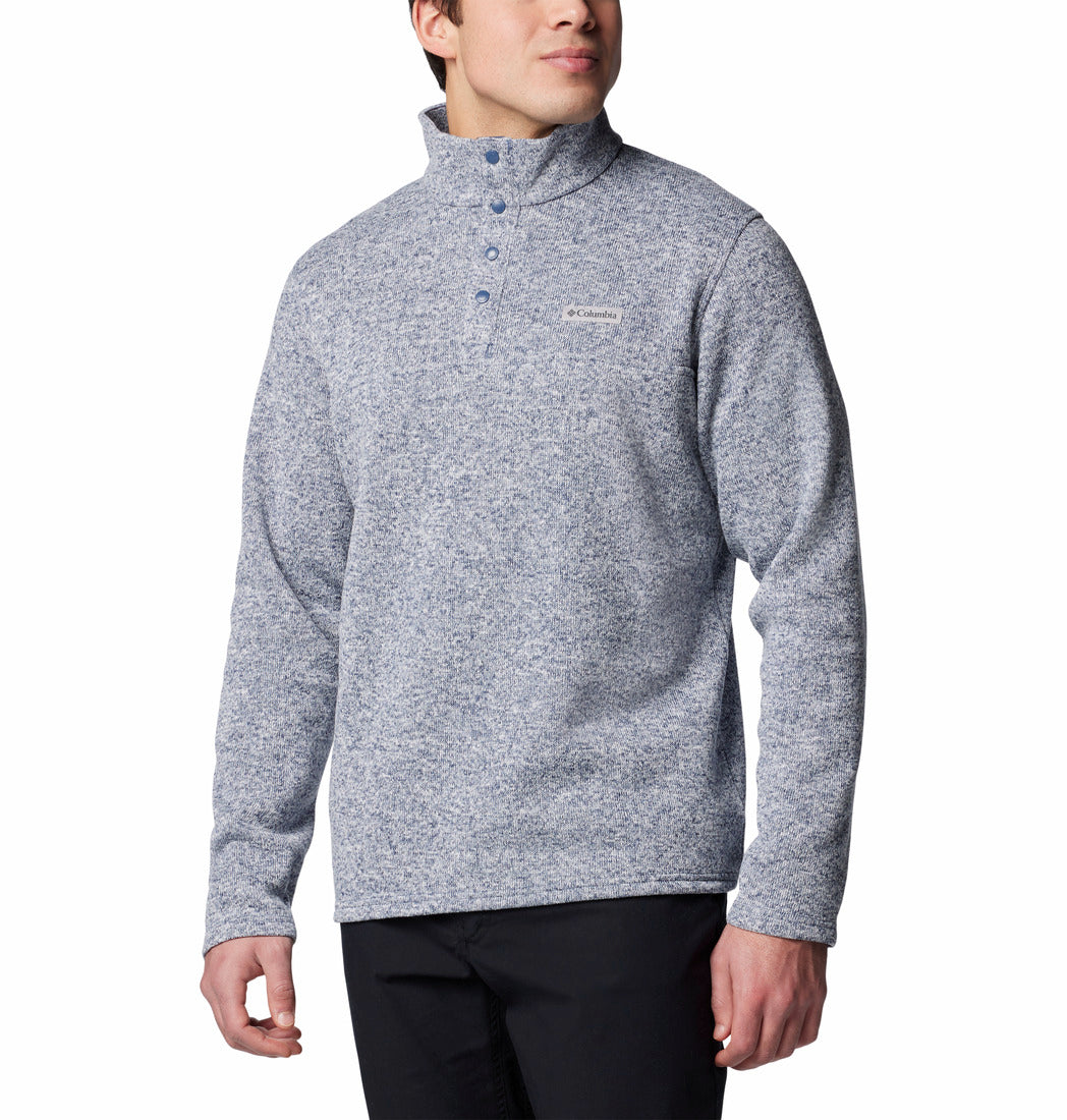 Person wearing a gray pullover with a brand logo on a white background