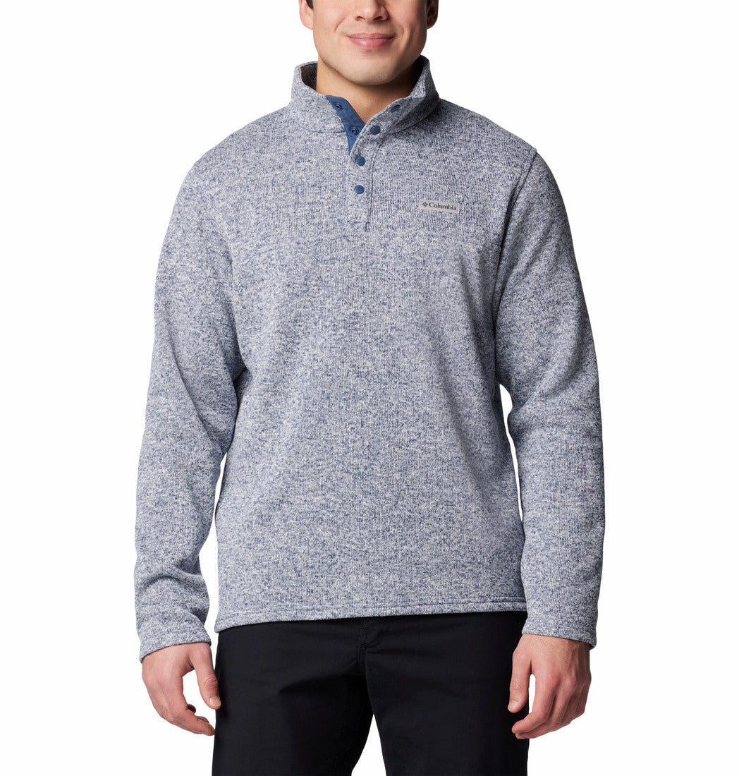 Man wearing a gray pullover with a visible brand logo on a white background
