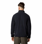Man wearing a black fleece jacket on a white background