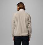 Person wearing a beige fleece jacket on a gray background-Back view