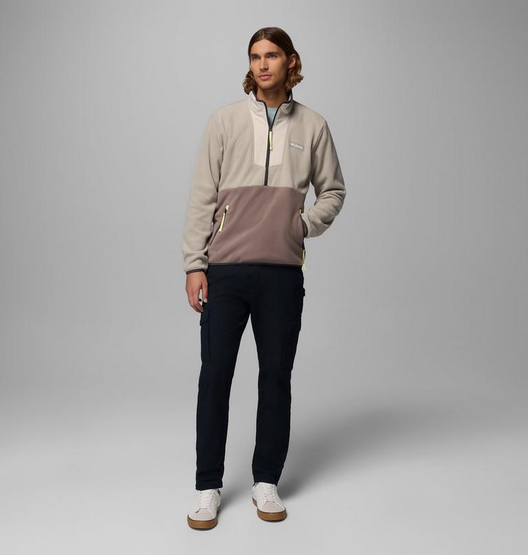 Man wearing a two-tone pullover with a gray and brown design on a gray background