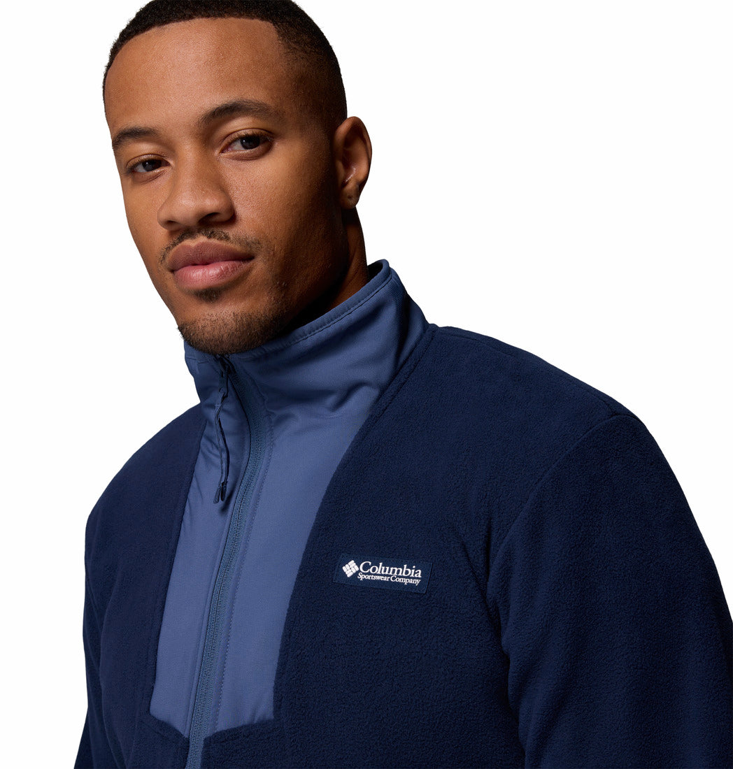 Man wearing a blue Columbia jacket on a white background