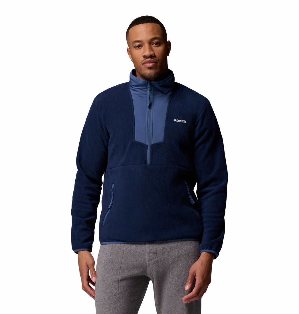 Man wearing a navy blue pullover with Columbia logo on a white background