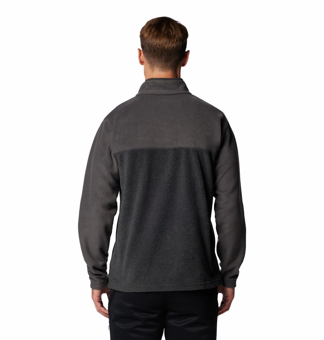 Person wearing a dark gray fleece jacket on a white background