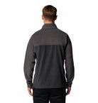 Person wearing a dark gray fleece jacket on a white background