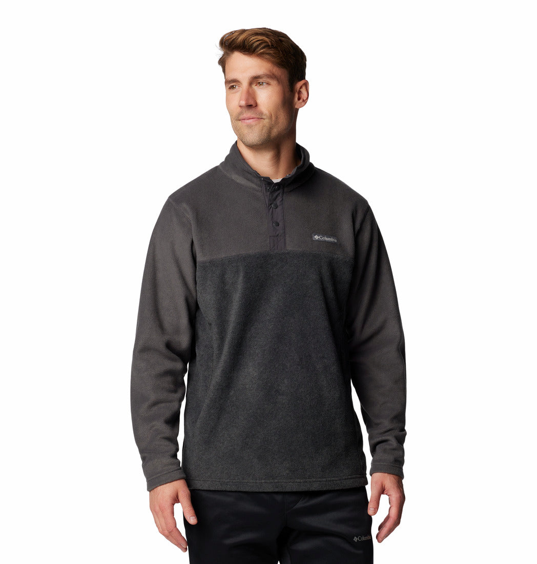 Man wearing a dark gray pullover with a brand logo on a white background