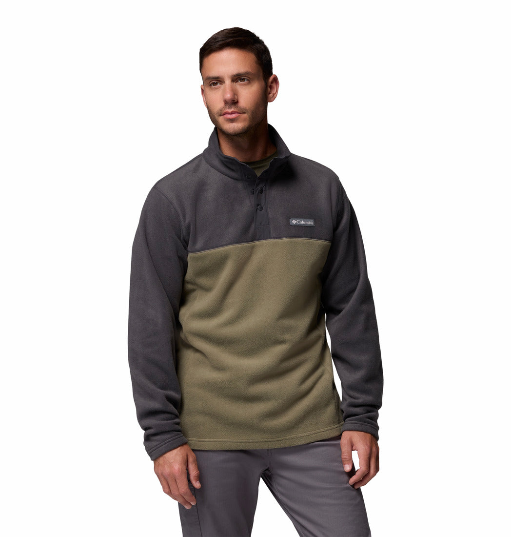 Man wearing a two-tone fleece pullover with a visible brand logo on a white background