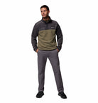 Man wearing a two-tone fleece pullover and pants on a white background