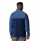 Man wearing a blue pullover with a white background