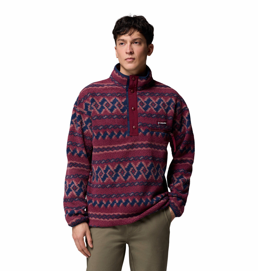Man wearing a patterned pullover with a white background