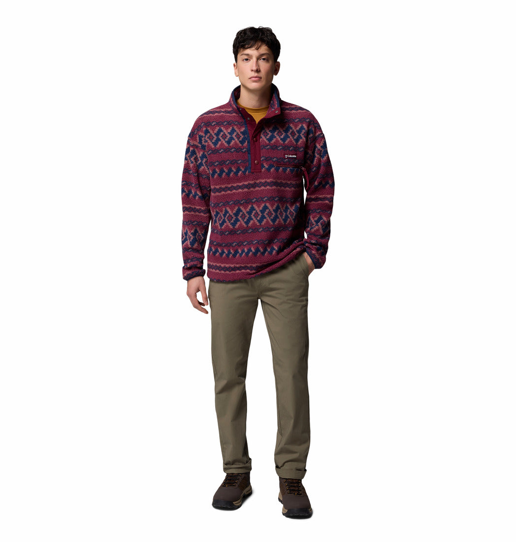 Man wearing a patterned pullover with a white background