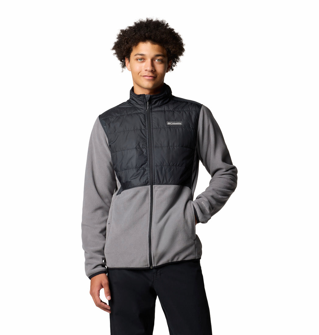 Person wearing a two-tone jacket with a visible brand logo on a white background