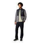 Person wearing a two-tone jacket with a white background