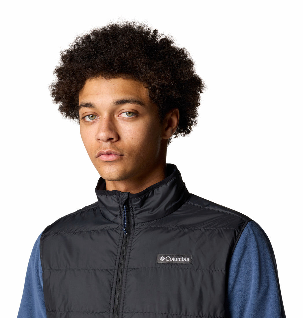 Person wearing a Columbia vest on a white background