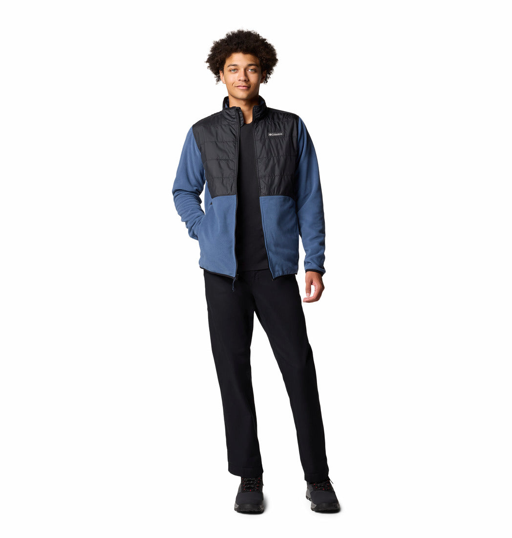 Person wearing a blue and black jacket on a white background