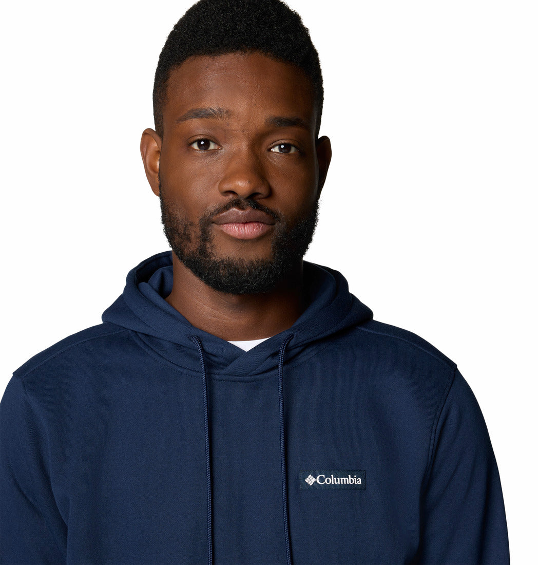 Man wearing a navy blue Columbia hoodie on a white background