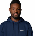 Man wearing a navy blue Columbia hoodie on a white background