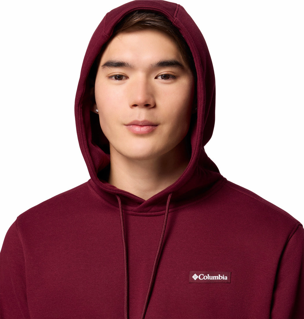 Person wearing a maroon hoodie with Columbia logo on a white background