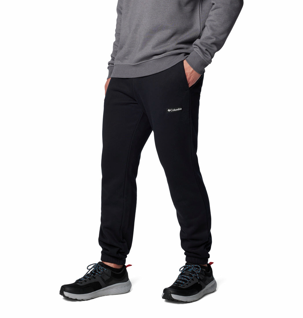 Person wearing black Columbia sweatpants on a white background