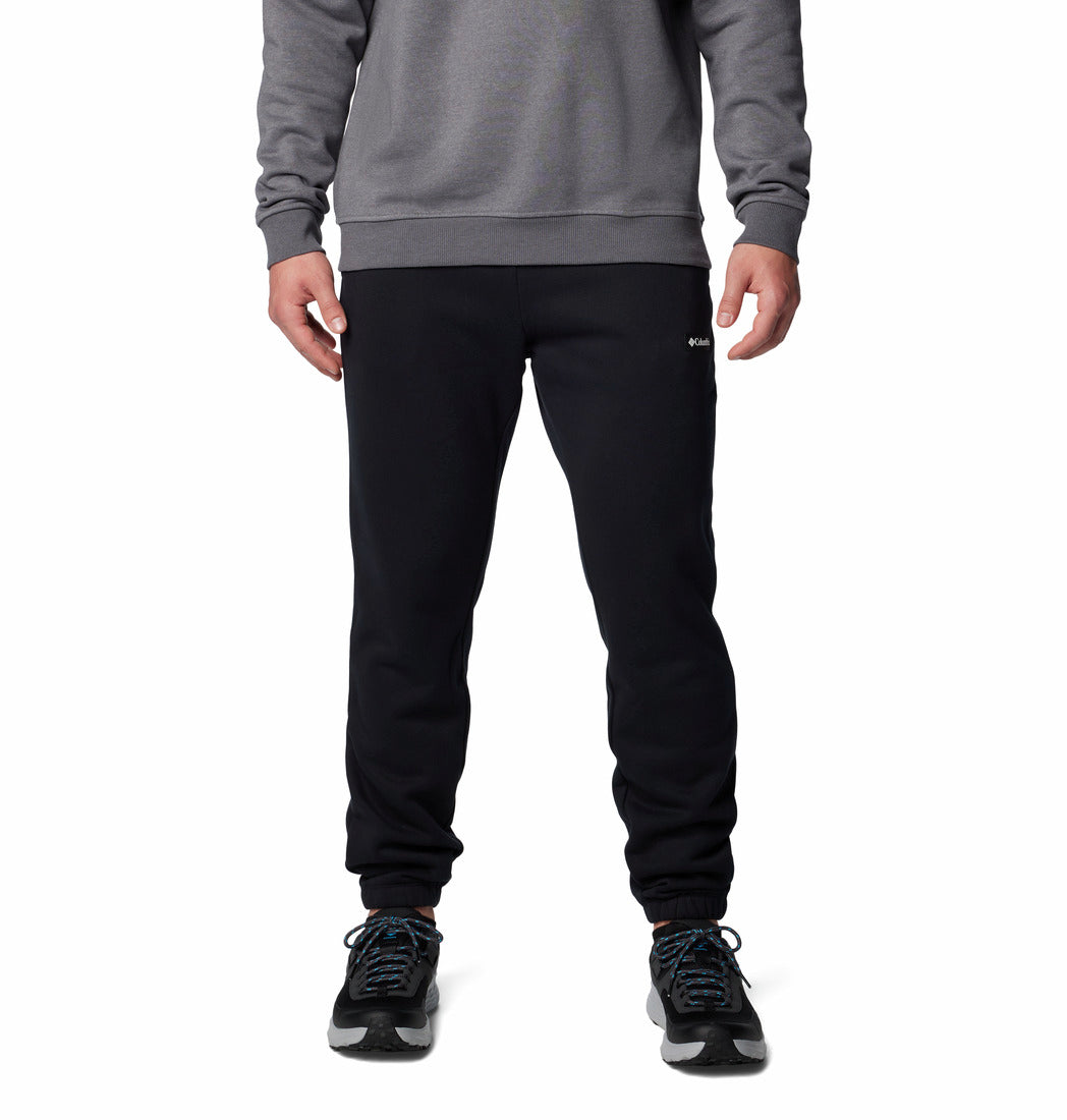 Person wearing black sweatpants and a gray sweatshirt on a white background